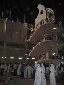 Men in thobes outside football stadium